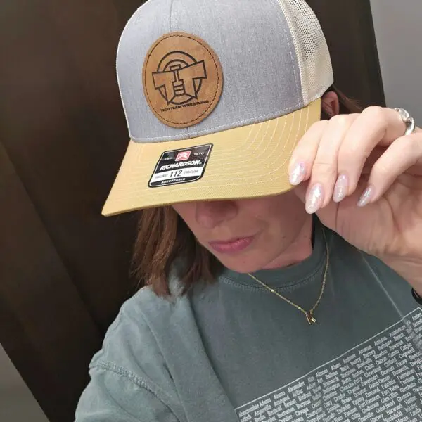 A woman wearing a hat and looking at her phone.