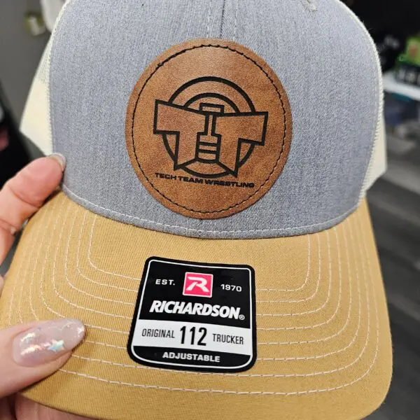 A person holding onto a richardson hat