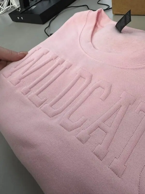 A pink shirt with the word " mecca ".