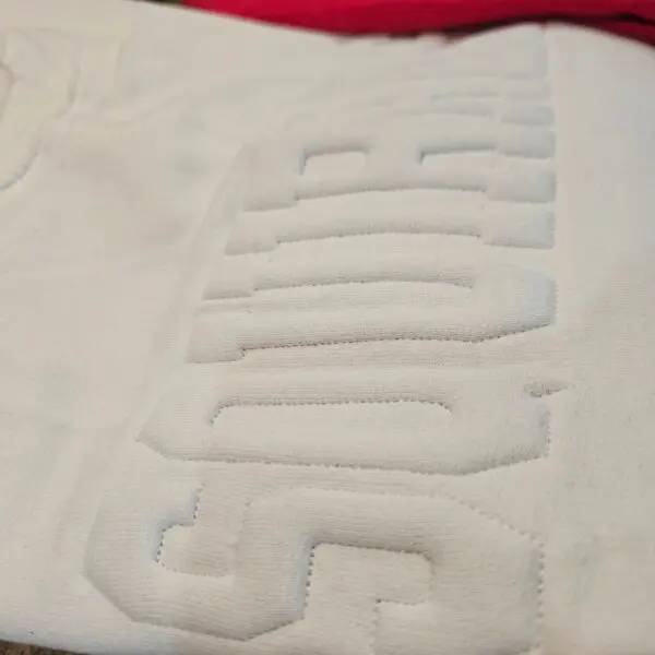A close up of the letters on a white shirt