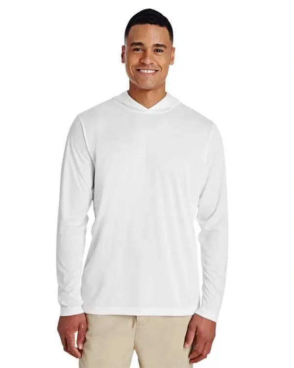 A man wearing white long sleeve shirt and beige shorts.