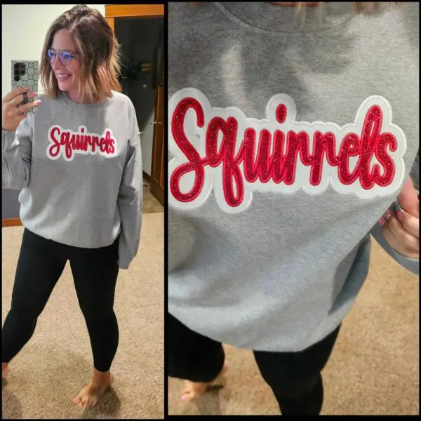 A woman taking a selfie of her squirrel sweatshirt.