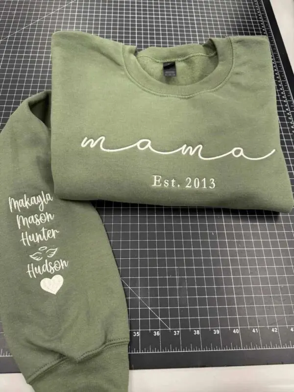 A green shirt and sweatshirt with the word mama written on it.