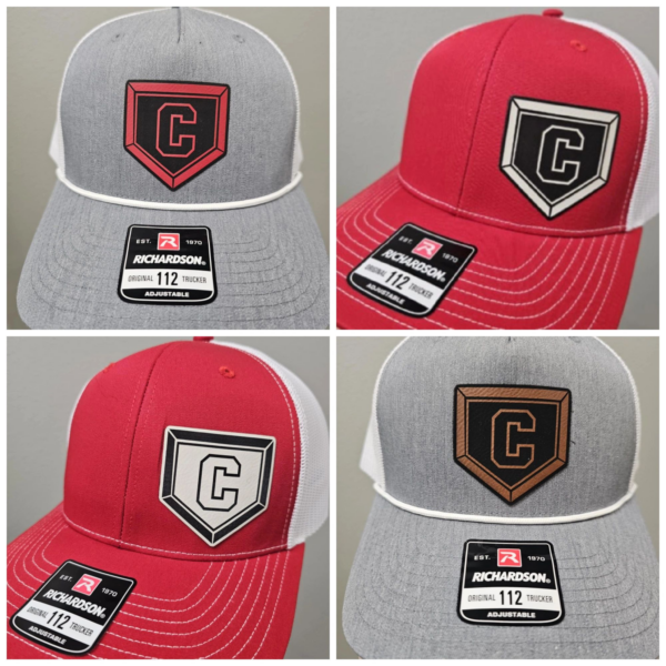 A group of four different baseball hats with patches.