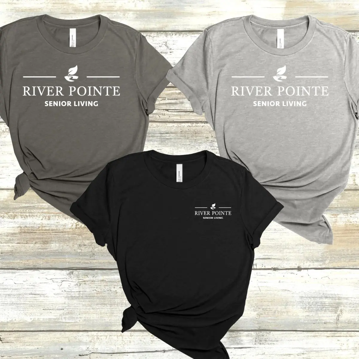 Three different colored shirts with river pointe logo.