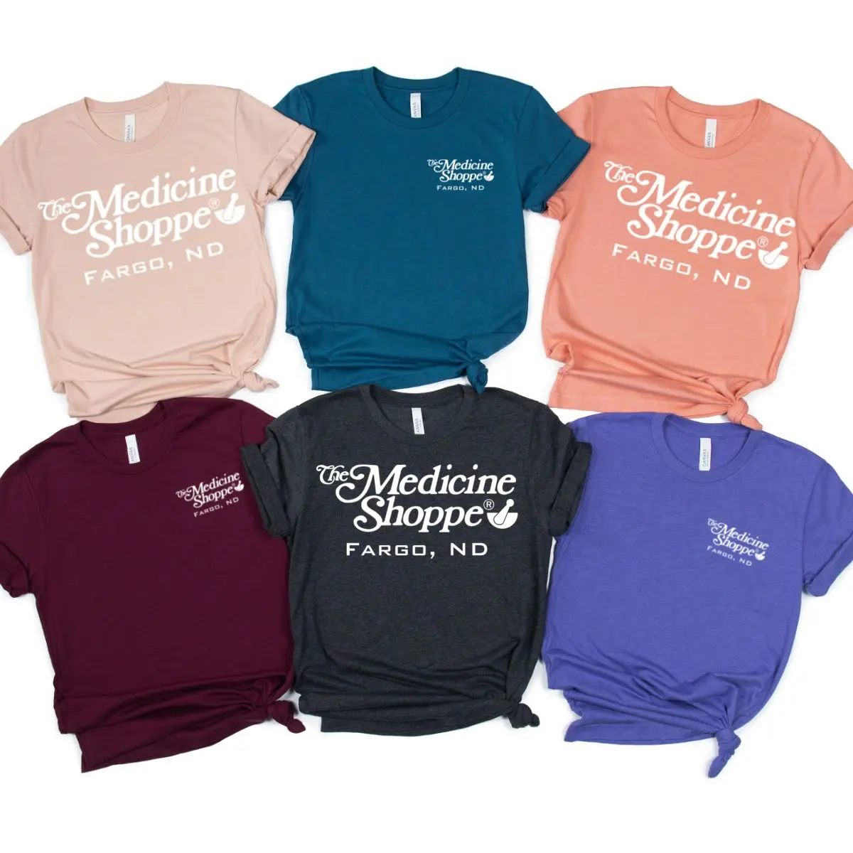 A group of different colored shirts with the words " medicine shoppe fargo, nd ".