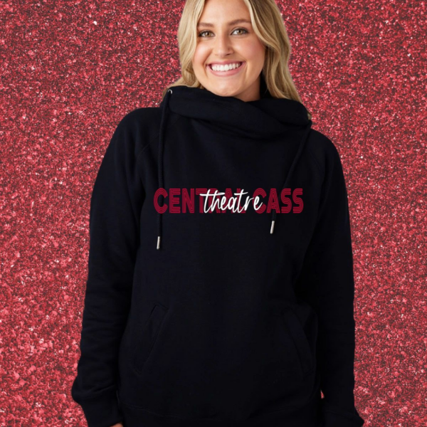 A woman standing in front of a wall with pink and red letters on it.