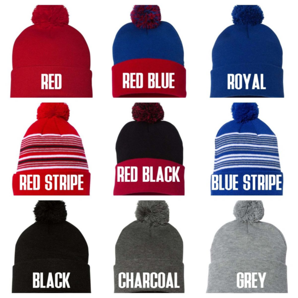 A variety of colors and styles of hats with pom poms.
