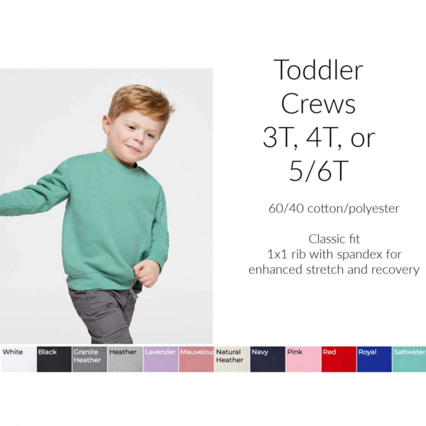 A young boy wearing a sweatshirt with the words toddler crews 3 t, 4 t or 5 / 6 t.