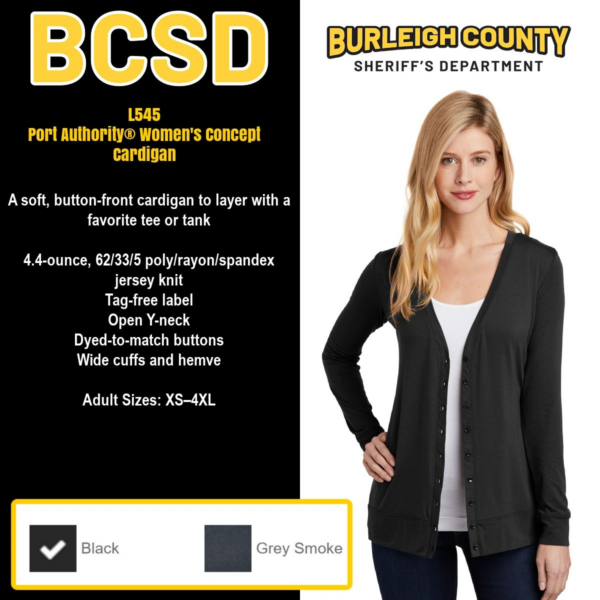 A woman wearing black cardigan and gray shirt.