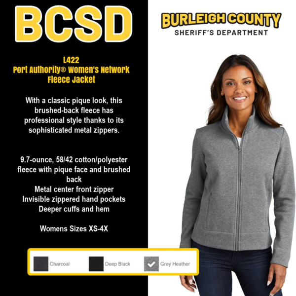 A woman wearing a gray jacket and black pants.