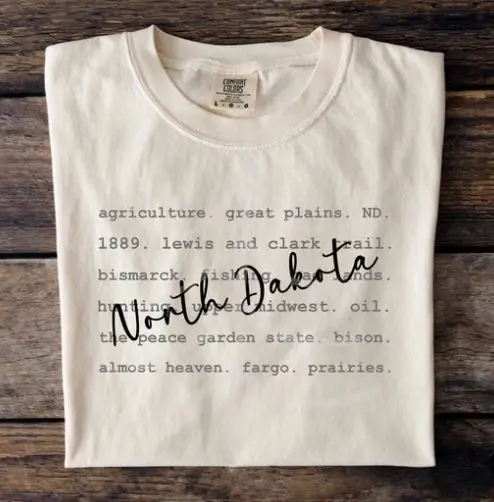 A white shirt with the words north dakota written on it.