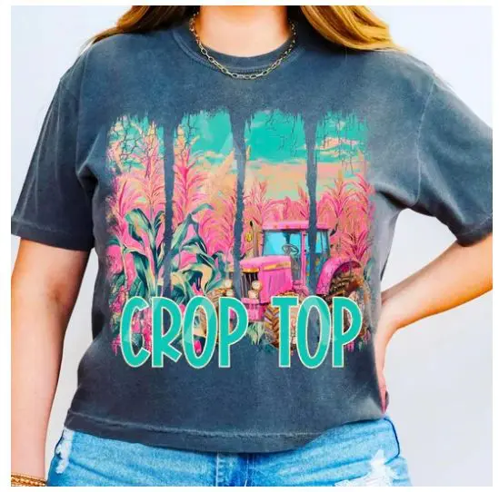 A woman wearing crop top shirt standing next to window.
