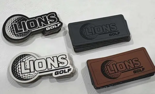A group of four different colored lions golf magnets.