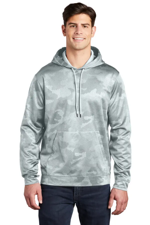 A man wearing a gray hoodie with trees in the background.