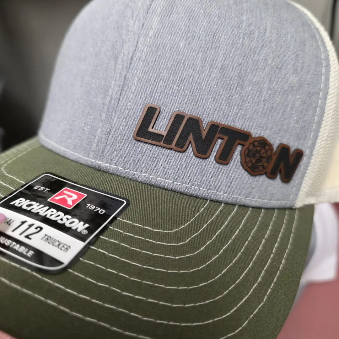 Gray and green cap with "LINTON" logo.