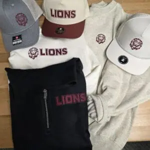 Lions apparel and hats on display table.