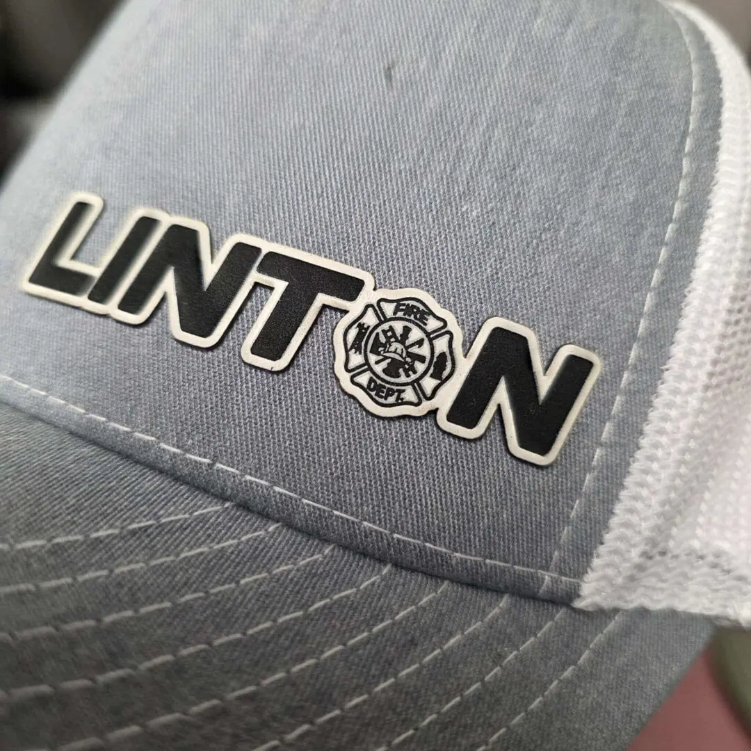 Gray cap with "Linton" and fire emblem.