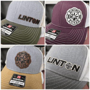 Four Linton branded caps, different designs.