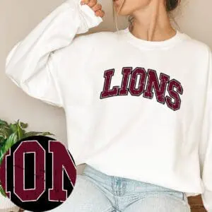 Woman wearing "Lions" sweatshirt, casual pose.