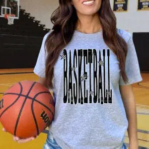 Woman holding basketball on gym court