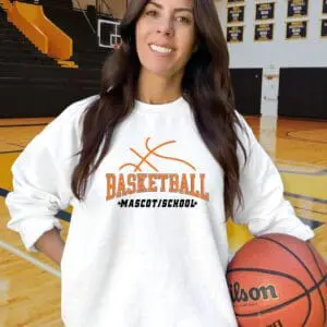 Woman holding basketball on indoor court.