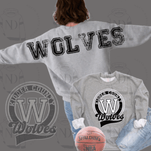 Person wearing gray Wolves sweatshirt with basketball