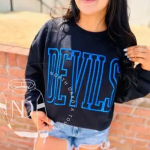 Woman wearing "Devils" North Dakota sweatshirt