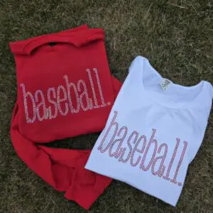 Red and white baseball shirts on grass