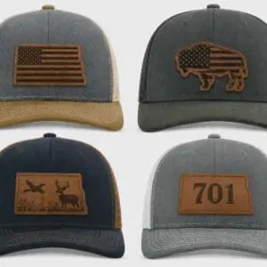 Four trucker hats with leather patch designs