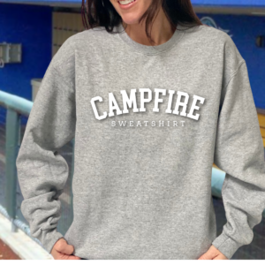 Person wearing gray sweatshirt with "CAMPFIRE" text