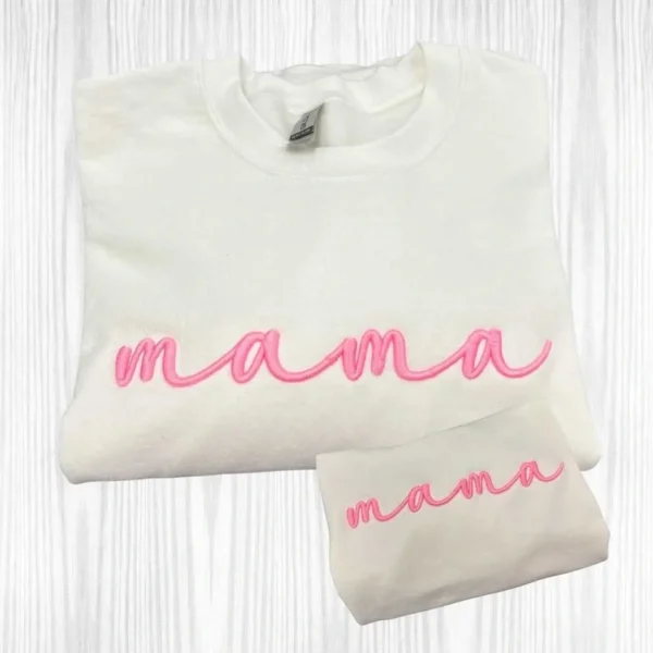 White sweatshirt with "mama" in pink lettering.