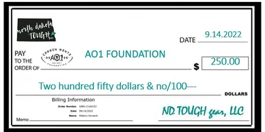 A large cheque that is in front of a picture.