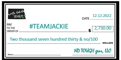 A cheque with the name of jackie and the date.